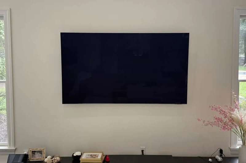 TV mounted and centered on the wall, cable hidden