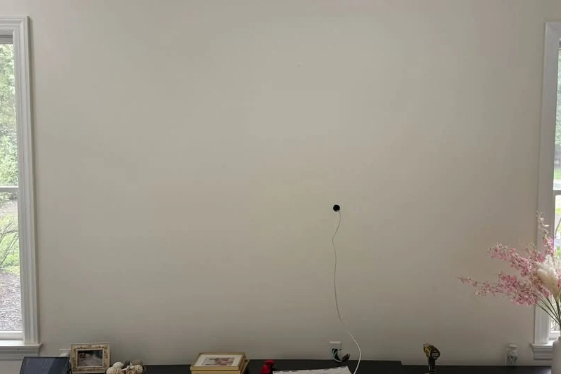 Empty wall with loose cable before TV mounting